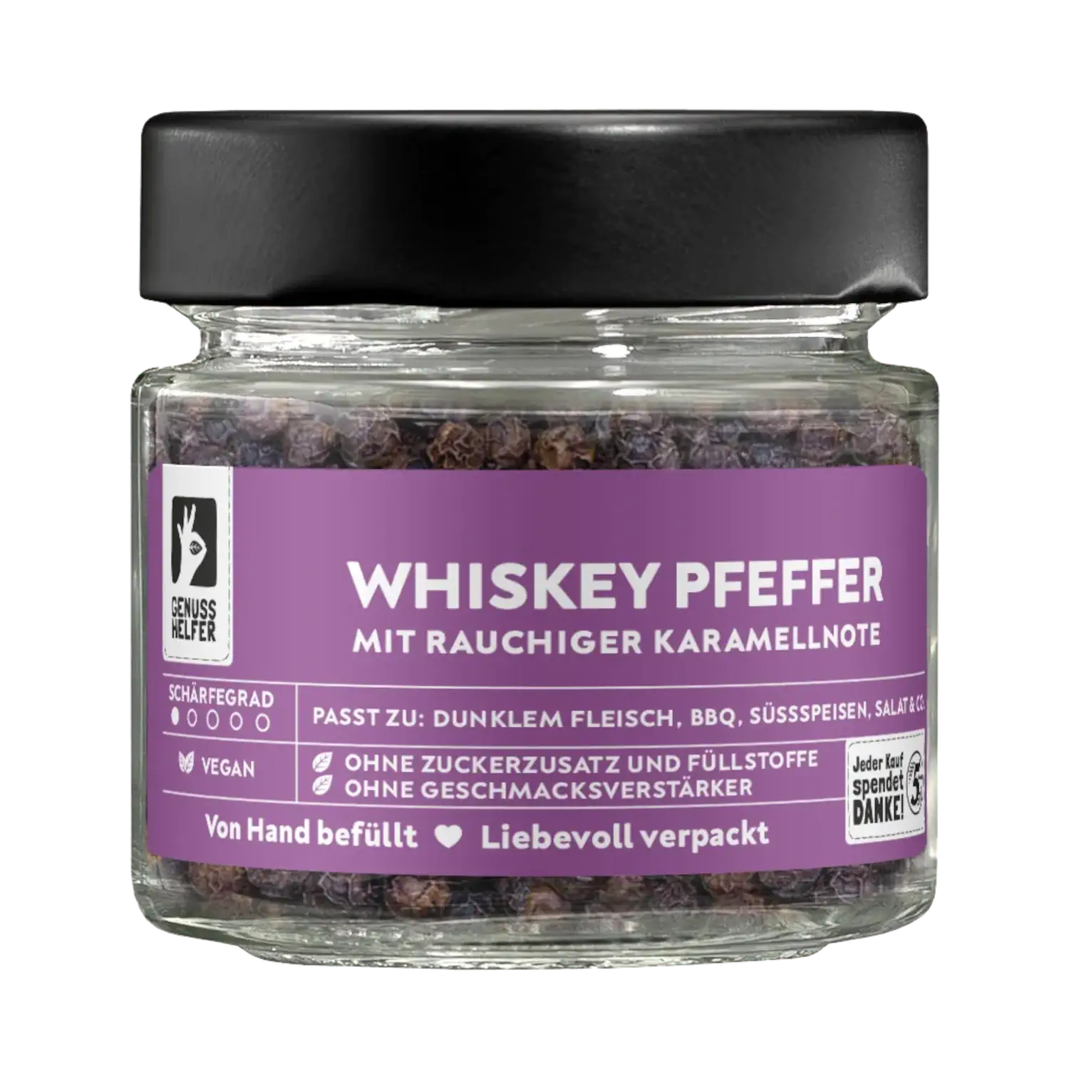 Whiskey Pfeffer, ganz, Tellicherry Pfeffer, im Glas Vorderansicht eines Glases mit Whiskey-Pfeffer